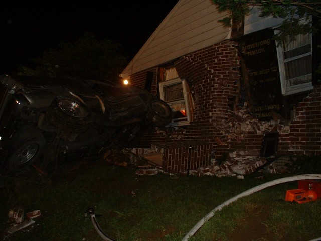 This pickup traveled down an embankment, across a meadow and yard and crashed into this home; Rt. 340 & Martin Road...5/23/04